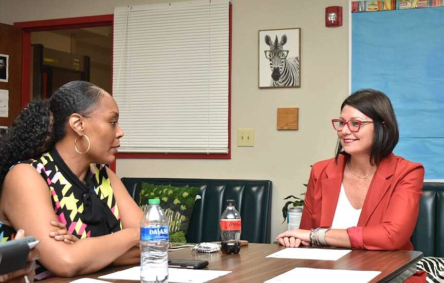 Pine Bluff School District board trustee Jomeka Edwards and Superintendent Jennifer Barbaree at table